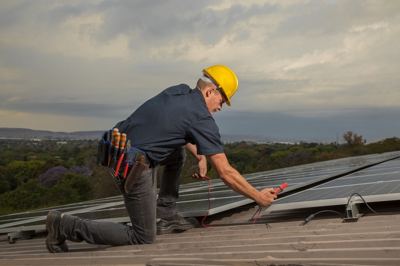Industrial photography_technician testing solar panels