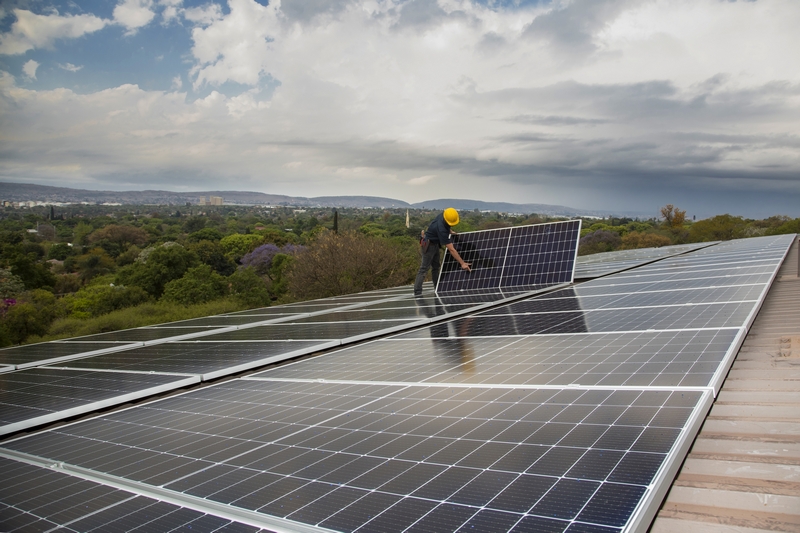 Installing solar panels on complex roof_industrial photography