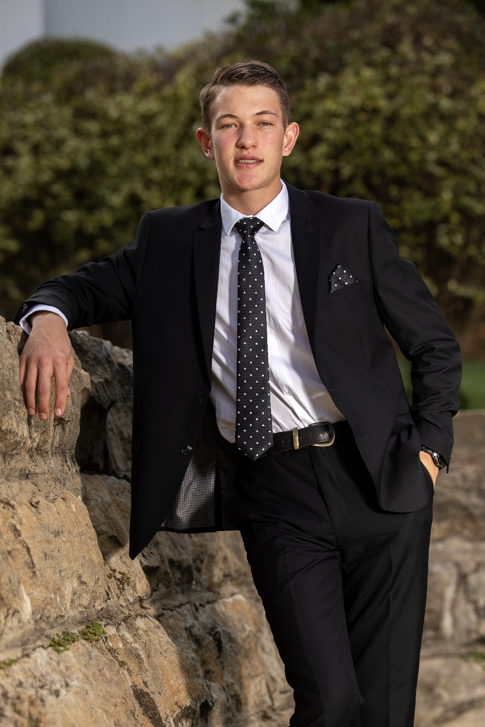 Matric farewell _ young man portrait _ leaning on stonewall