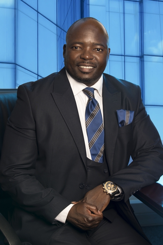 Mr Gumbochuma QCTO blue background glass Professional profile photo Mr Gumbochuma QCTO Portrait