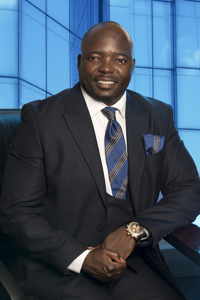 Mr Gumbochuma QCTO blue background glass_business portrait photography