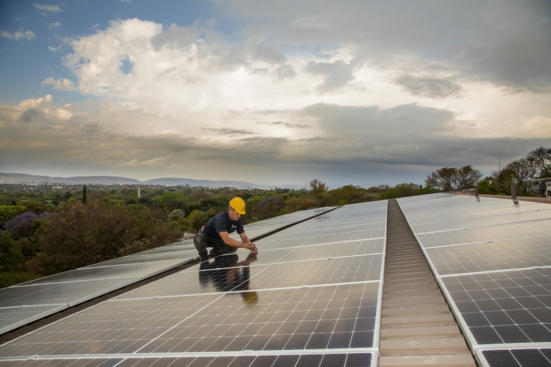 Technician installing solar panels_industrial photograpy