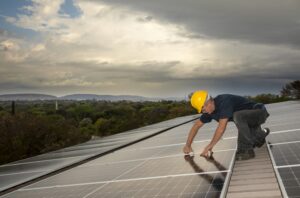 Technician securing a solar panel_industrial photography Technician securing a solar panel_industrial photography