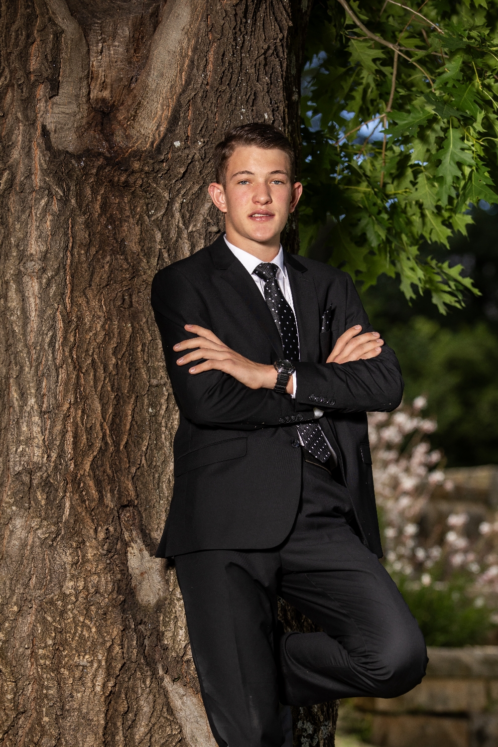 Young man leaning against oak tree _ matric farewell